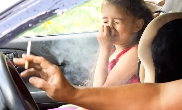 A child struggling to breathe due to exposure to passive smoking