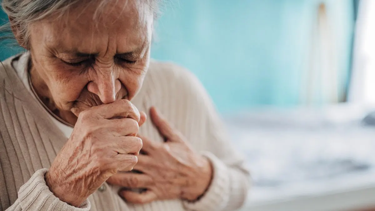 An elderly person experiencing respiratory distress due to exposure to secondhand smoke